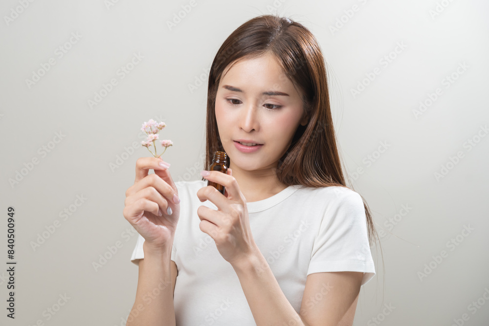 Aromatherapy, pretty asian young woman face expression enjoying smell fragrance of herbal from medicine natural organic essential perfume oil.Therapy treatment, beauty skin care isolated on background Aromatherapy, pretty asian young woman face expression enjoying smell fragrance of herbal from medicine natural organic essential perfume oil.Therapy treatment, beauty skin care isolated on background