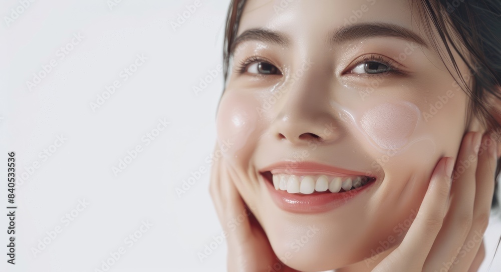 A portrait of a beautiful Asian woman with bright skin who has good health. She is smiling with confidence and a charming face while touching her well cared skin. A portrait of a beautiful Asian woman with bright skin who has good health. She is smiling with confidence and a charming face while touching her well cared skin.
