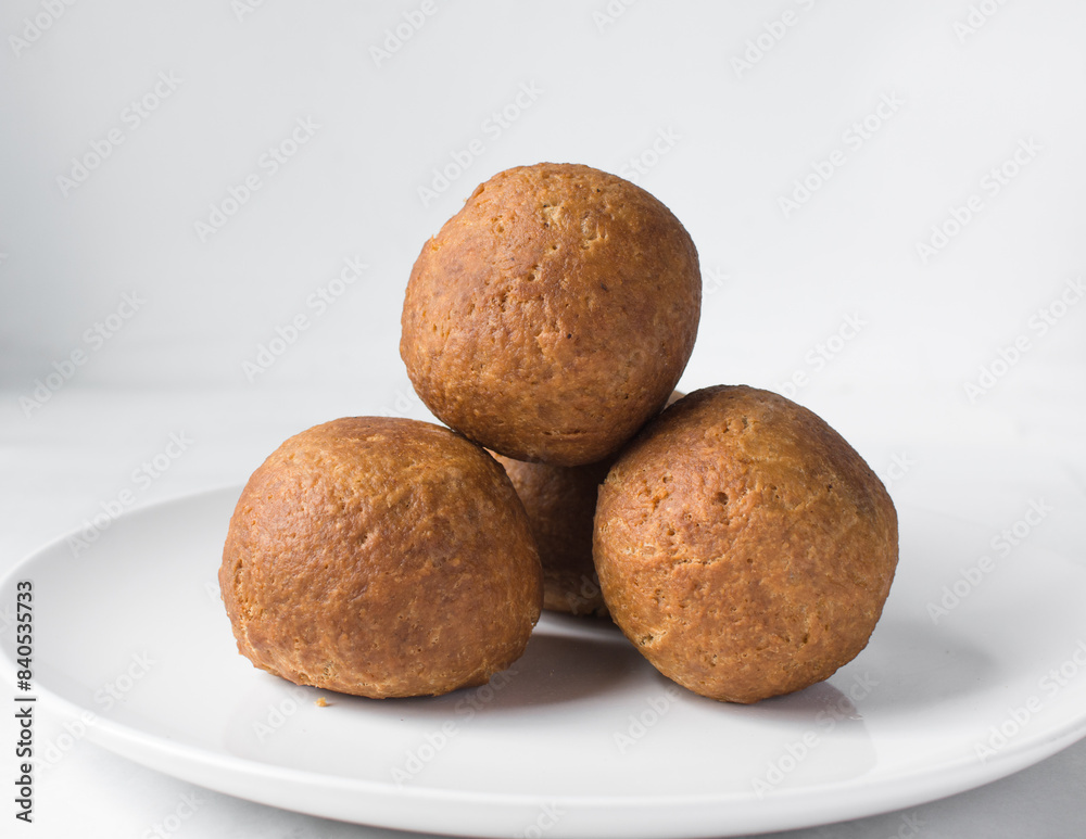 homemade nigerian egg roll in a white ceramic plate, freshly made african egg roll on a white plate, egg wrapped in fried dough homemade nigerian egg roll in a white ceramic plate, freshly made african egg roll on a white plate, egg wrapped in fried dough