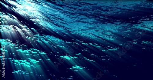 A seamless looping motion background featuring underwater ocean waves rippling and flowing, illuminated by light rays penetrating the water. Ideal for enhancing video projects, presentations, and digi photo