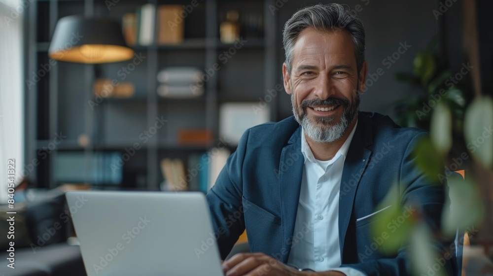Obraz premium Businessman executive using laptop at desk. Businessman manager working on computer in middle age.