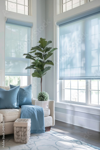 Light blue roller blinds hang on the windows in the room  modern fashionable interior design.