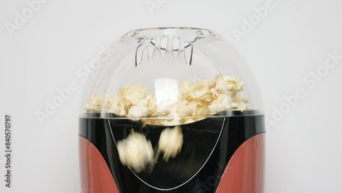 Close up view on home popcorn maker making fresh crispy popcorn. Popcorn popper or machine for doing home popcorn photo