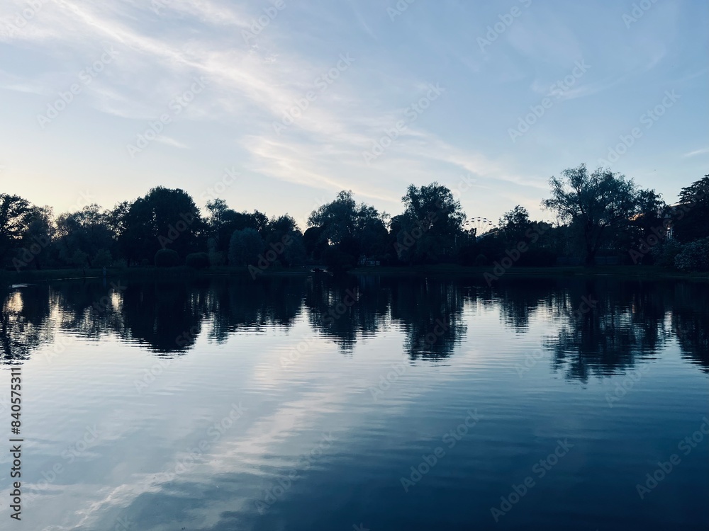 Fototapeta premium twilights at the park, sky and trees silhouettes reflection on the water surface, pond in the park, evening, summer