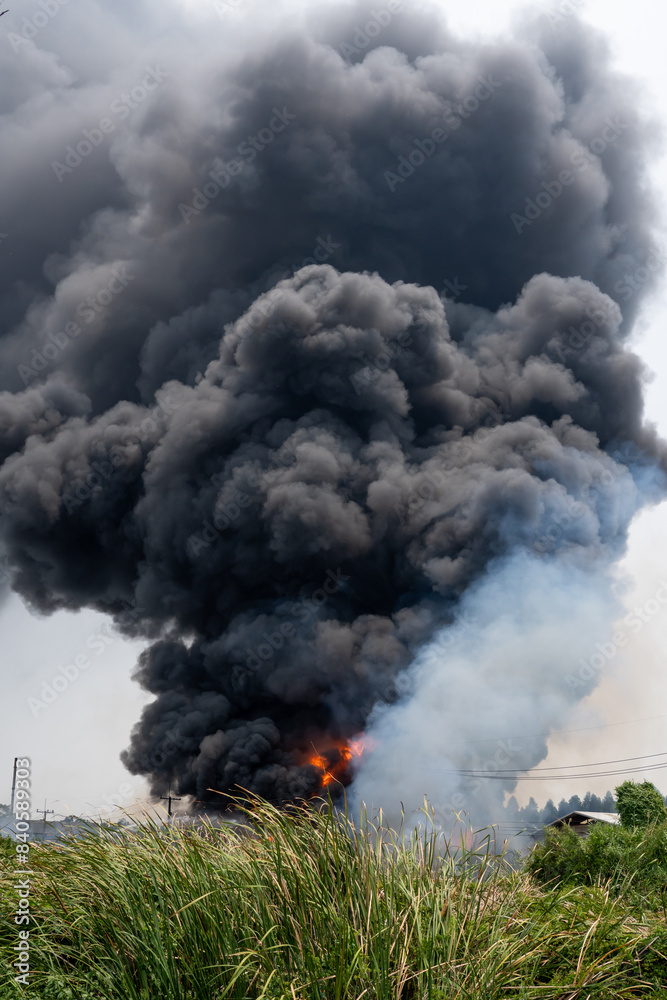 Black smoke caused by burning plastic from cause of fire industrial plant Black smoke caused by burning plastic from cause of fire industrial plant