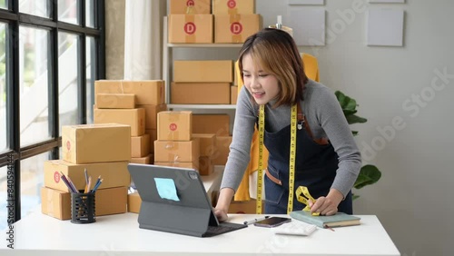 A woman is sitting at a desk with a box in front of her