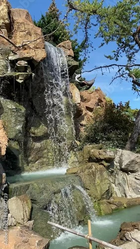 Cliffside Waterfall with Vibrant Blue Sky Background