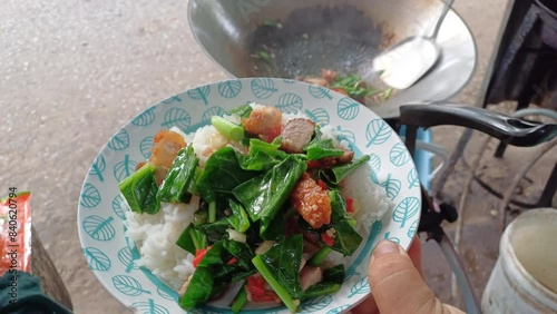 Stir fried kale with crispy pork in oyster sauce. Thai street food called kana moo krob 