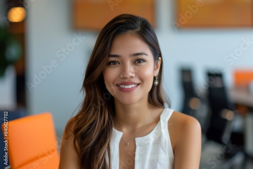 Portrait of filipina woman beautiful business leader, in modern bright office boardroom, professional atmosphere, leadership, diverse workplace, corporate setting.