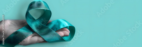 Teal awareness ribbon awareness for Ovarian Cancer month, cervical cancer, Polycystic Ovary Syndrome (PCOS) disease, Post Traumatic Stress Disorder (PTSD), Obsessive Compulsive Disorder (OCD) photo