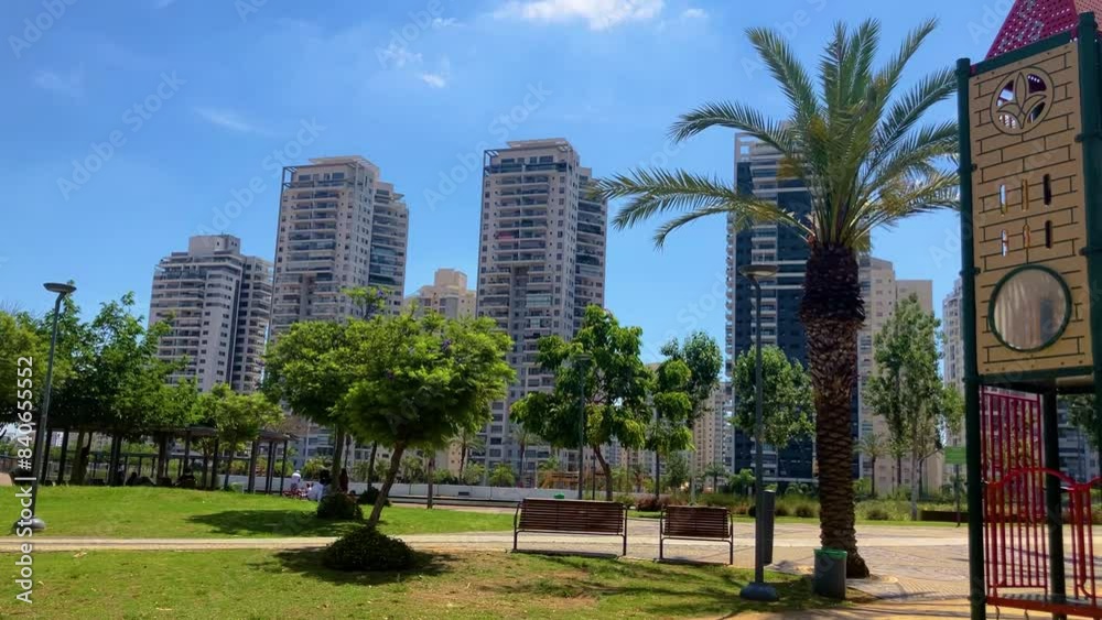 High-rise residential buildings near a park and a picturesque pond. An ideal place to live, a modern, prosperous area. Luxury real estate.