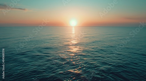 A serene scene of sunset over the ocean on a clear day