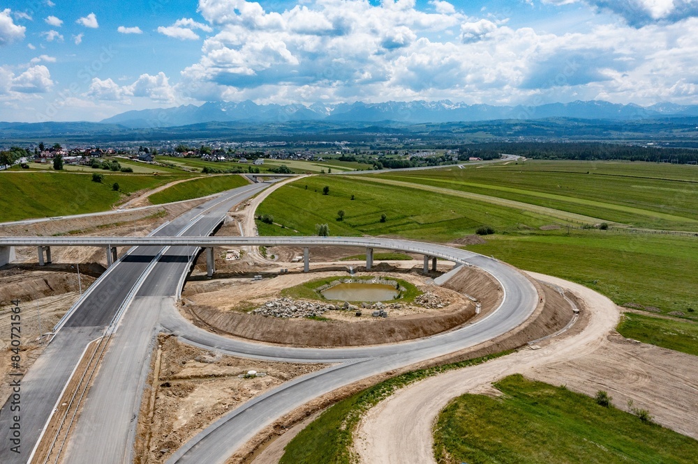 Drone shot of the highway construction from Krakow to Zakopane in the summer. The road will lead into the Polish Tatra Mountains.