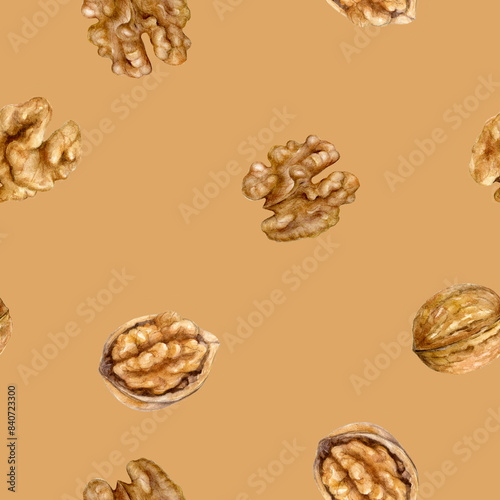 This is a seamless watercolor pattern featuring walnuts in shells and halves on a brown background photo