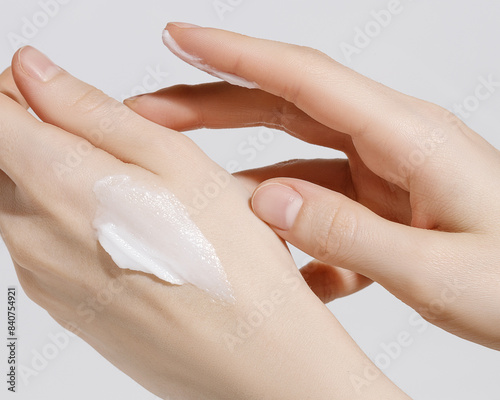 Woman applying hand cream. Copy space. Closeup. photo