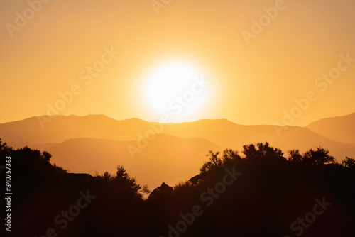 Los Angeles dawn sun rising behind Verdugo Mountain above the San Fernando Valley.  