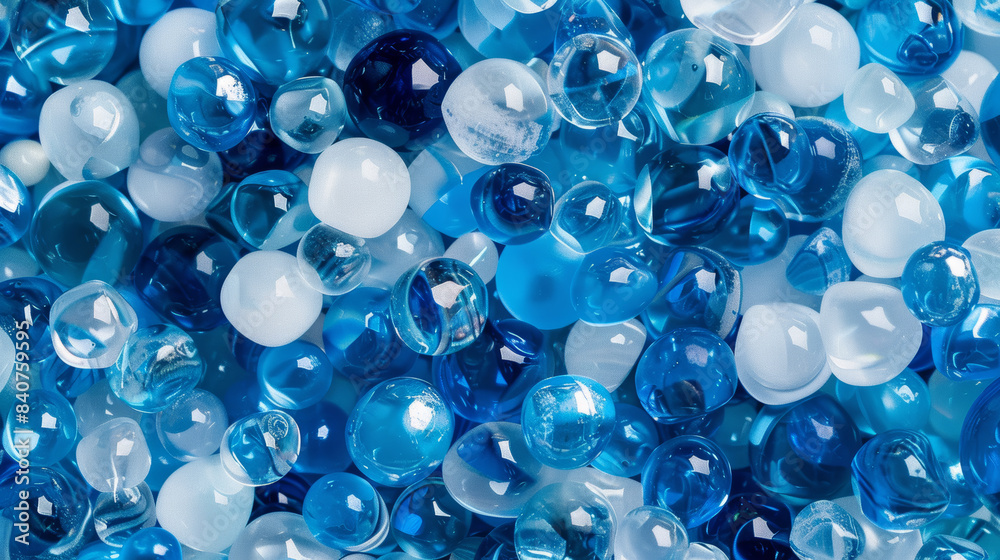 A collection of marbles in various shades of blue and white creates a vibrant and abstract visual display. A collection of marbles in various shades of blue and white creates a vibrant and abstract visual display.