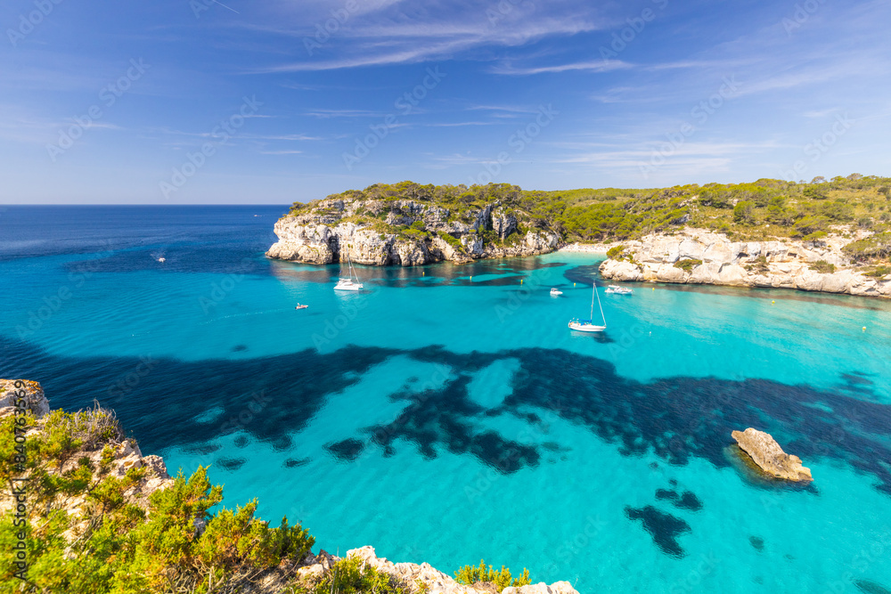 Macarella beach on the coast of Menorca, beautiful seaside landscape, white cliffs, turquoise sea, picturesque place for a holiday in Spain