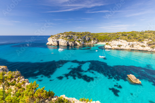 Obraz na płótnie Macarella beach on the coast of Menorca, beautiful seaside landscape, white cliffs, turquoise sea, picturesque place for a holiday in Spain w salonie