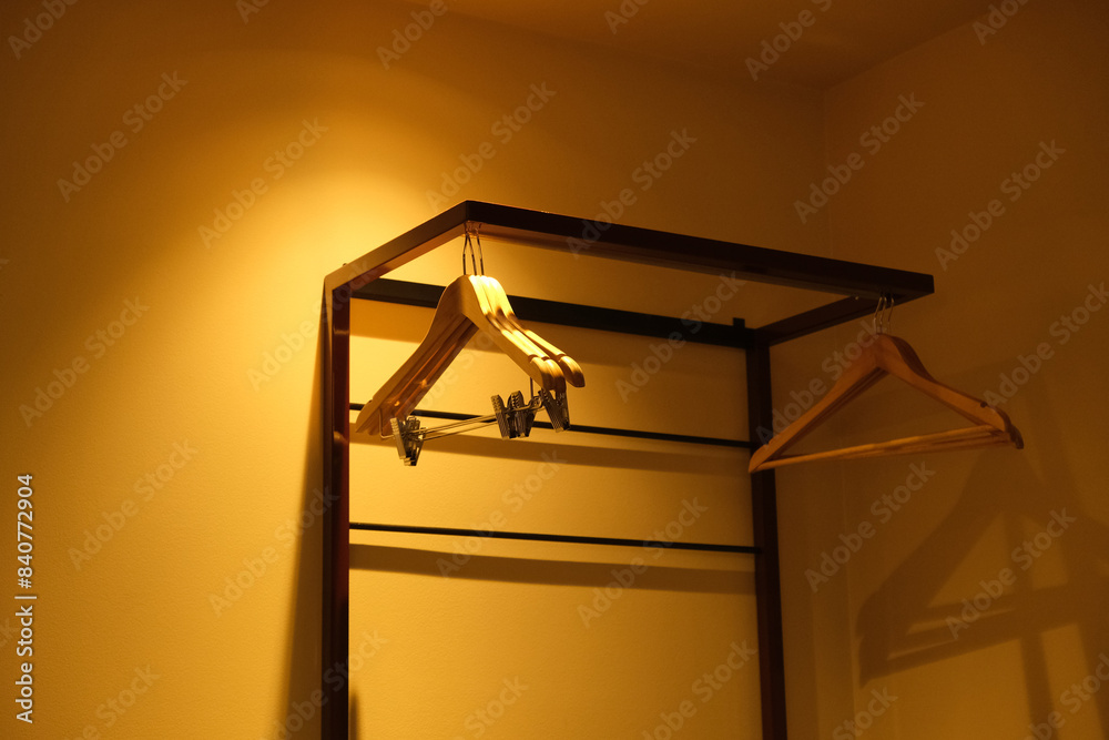 hangers under the light of a yellow lamp hangers under the light of a yellow lamp