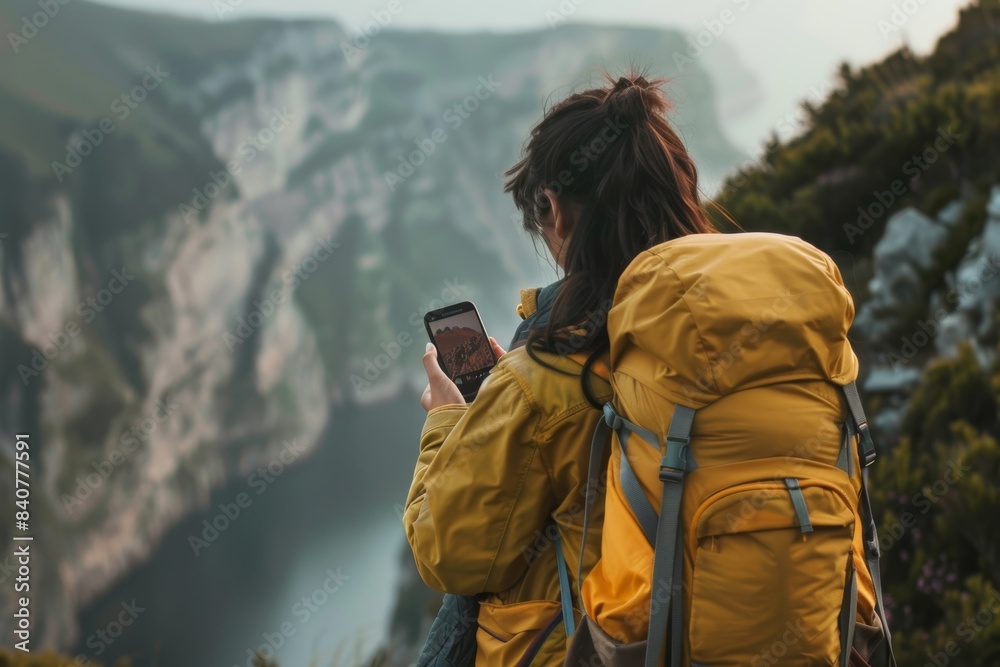 Adventurous Traveler Capturing Landscape with Mobile Device on Hiking Expedition - Stay Connected Adventurous Traveler Capturing Landscape with Mobile Device on Hiking Expedition - Stay Connected