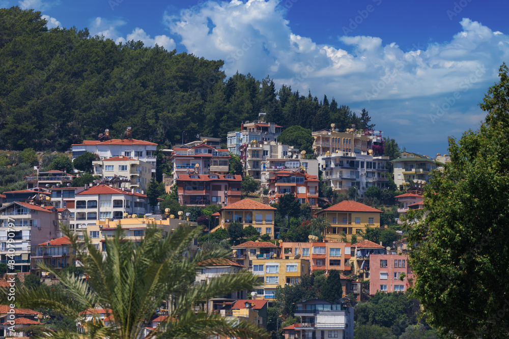 Obraz premium Southern cityscape, view of buildings and houses with green plants in public places in Turkey, sunny summer day in the city of Istanbul