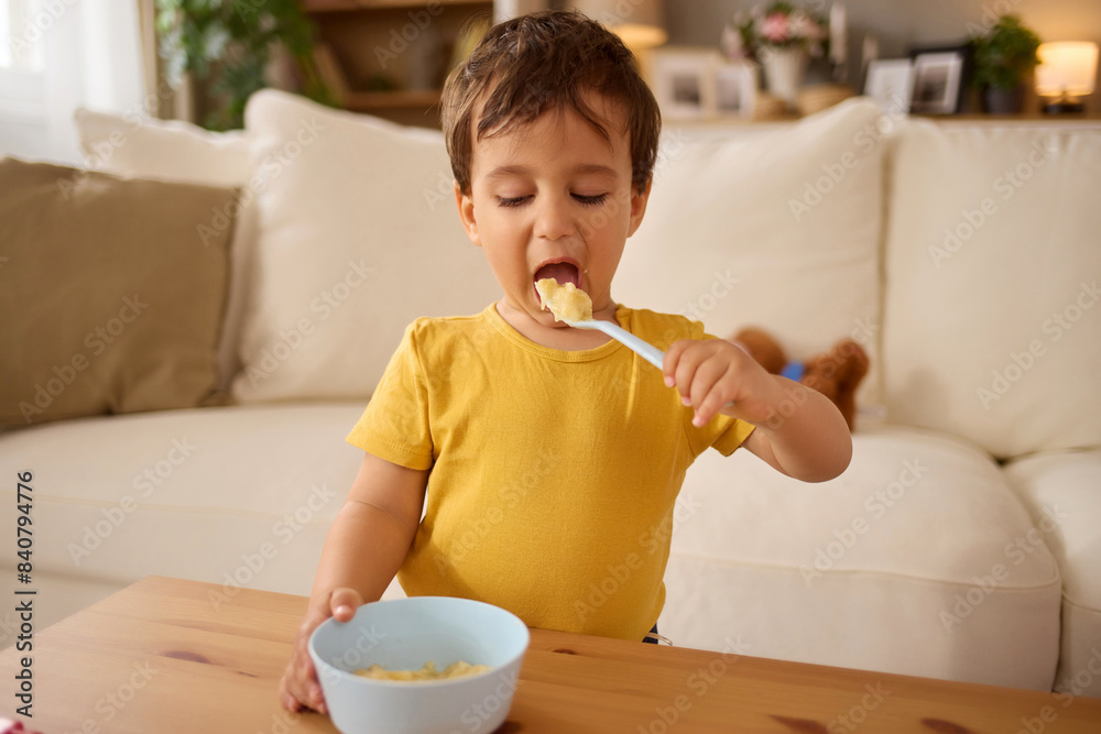Little boy having healthy meal in the living room Little boy having healthy meal in the living room