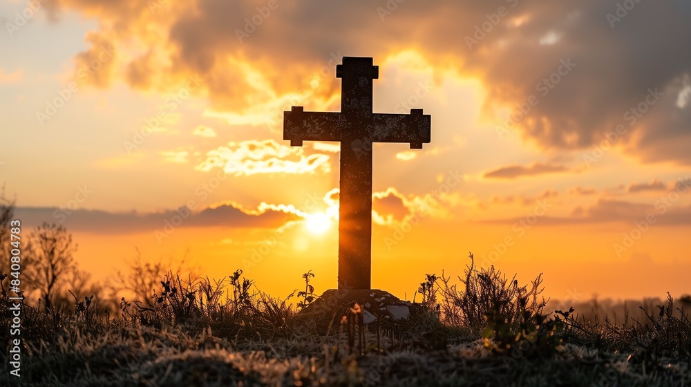 A serene image of a cross silhouetted against a vibrant sunset in a tranquil field. The warm colors and peaceful setting evoke feelings of reflection and reverence. A serene image of a cross silhouetted against a vibrant sunset in a tranquil field. The warm colors and peaceful setting evoke feelings of reflection and reverence.