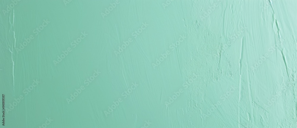 Subtle textured background is being formed by a refreshing mint green painted stucco wall. This cool color palette adds a touch of sophistication and tranquility to any design project Subtle textured background is being formed by a refreshing mint green painted stucco wall. This cool color palette adds a touch of sophistication and tranquility to any design project