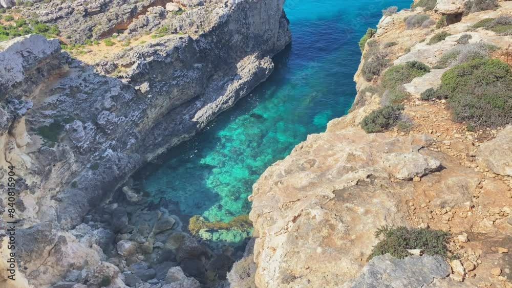 Beautiful Comino sea caves and Natural arches. Boat in the crystal clear mediterranean sea. Seen from the cliffs near Santa Marija tower. High quality 4k footage Beautiful Comino sea caves and Natural arches. Boat in the crystal clear mediterranean sea. Seen from the cliffs near Santa Marija tower. High quality 4k footage