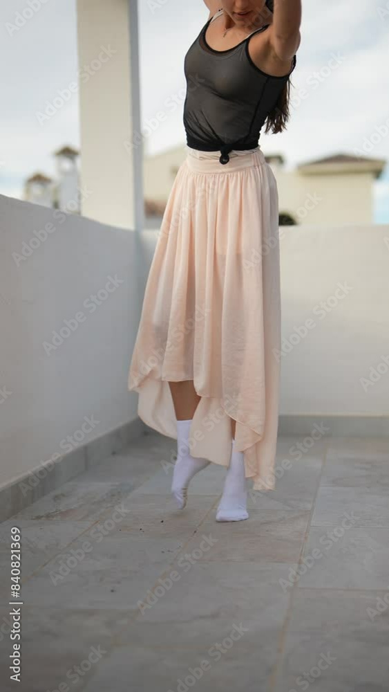 Woman gracefully dancing in modern setting with asymmetrical skirt, showing freedom and movement Woman gracefully dancing in modern setting with asymmetrical skirt, showing freedom and movement
