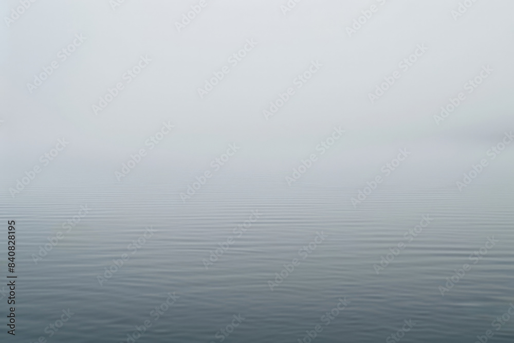 Minimalist seascape showing a tranquil water surface merging with a foggy sky, creating a serene and peaceful atmosphere Minimalist seascape showing a tranquil water surface merging with a foggy sky, creating a serene and peaceful atmosphere