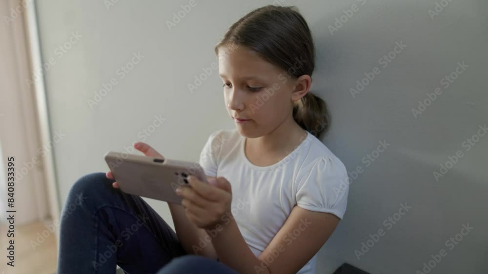 Girl sitting on the stairs and using a smartphone Girl sitting on the stairs and using a smartphone