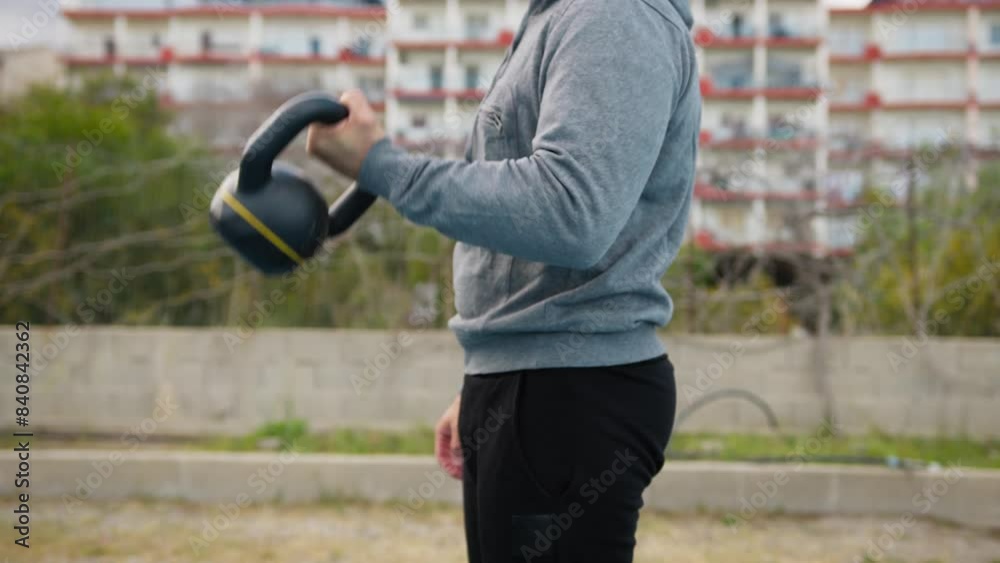 Man Trains Biceps With Gray Tracksuit Outdoors Man Trains Biceps With Gray Tracksuit Outdoors
