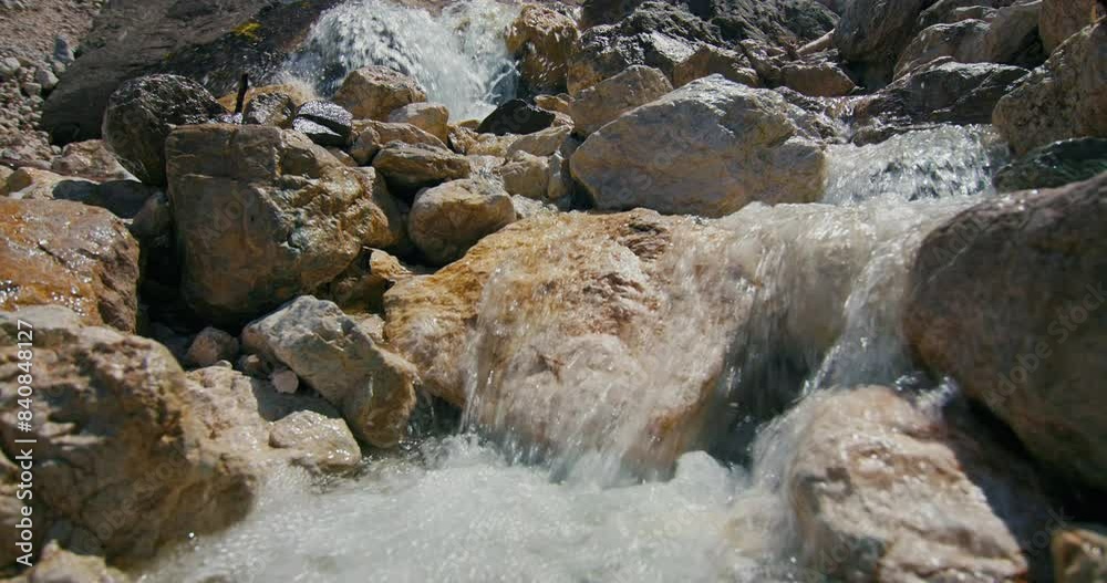 The nature of the waterfall in the Dolomite Alps. The water of the river flows down the rocks and stones in an incredible landscape of nature slow motion video. High quality 4k footage The nature of the waterfall in the Dolomite Alps. The water of the river flows down the rocks and stones in an incredible landscape of nature slow motion video. High quality 4k footage