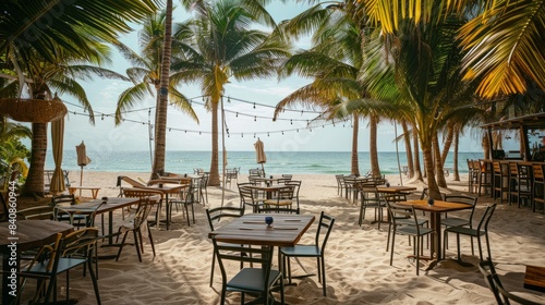 A cafe on a tropical beach with modern tables and chairs set up under palm trees