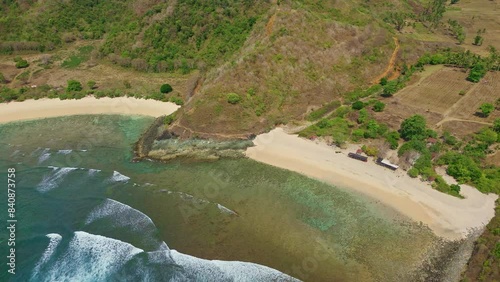 Aerial view of waves breaking on a coral reef next to a beach photo