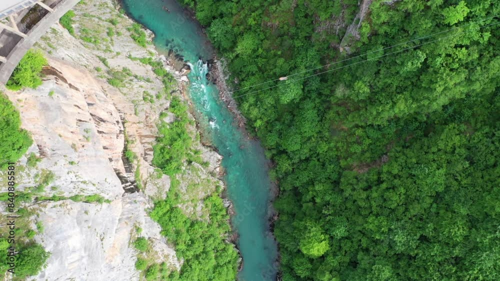 Zip line above canyon with turquoise river in the background Zip line above canyon with turquoise river in the background