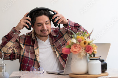 Young boy preparing his set to get fun with his laptop and play with headset