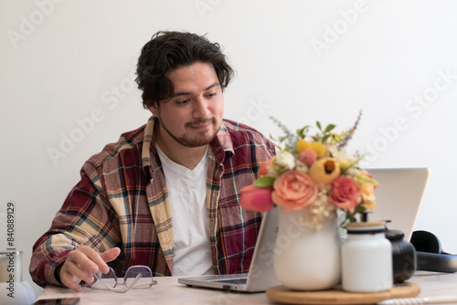 Young man using his laptop in the living room