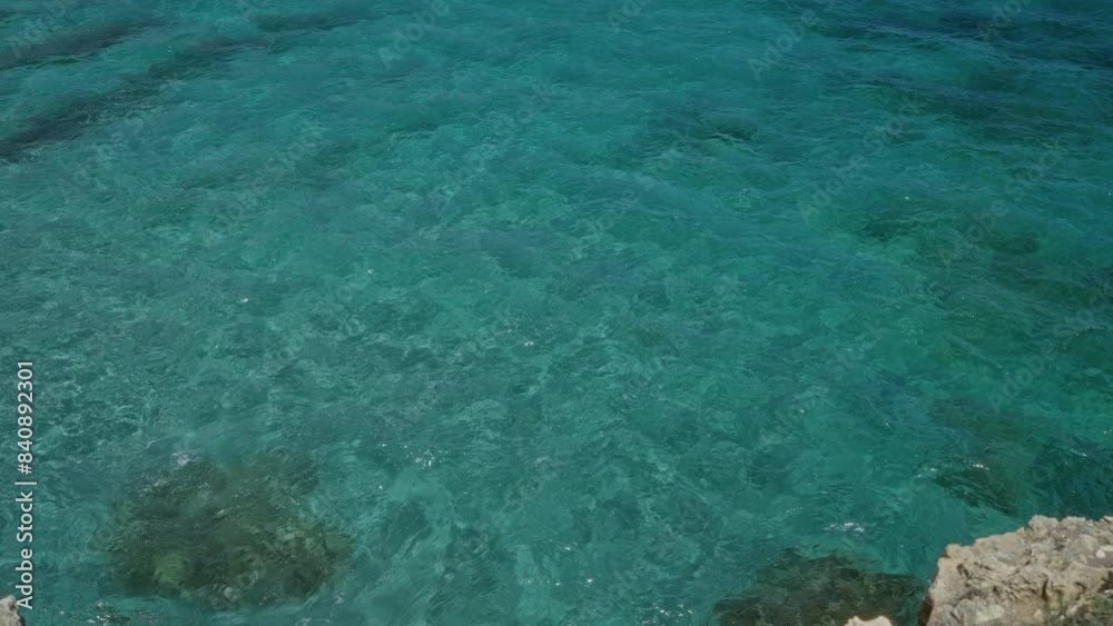 Clear turquoise water near the rocky edge of the cave of poetry in salento, puglia, italy, showcasing the captivating beach and coastal beauty of europe. Clear turquoise water near the rocky edge of the cave of poetry in salento, puglia, italy, showcasing the captivating beach and coastal beauty of europe.