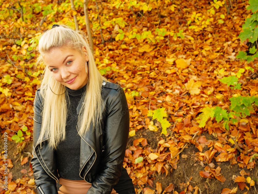 Fashion woman relaxing in autumn park