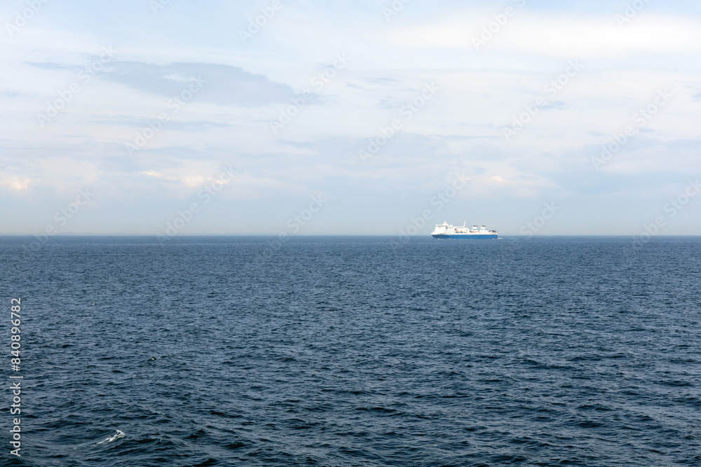 Seascape with a white ferry in the distance and waves. Sea transport Seascape with a white ferry in the distance and waves. Sea transport