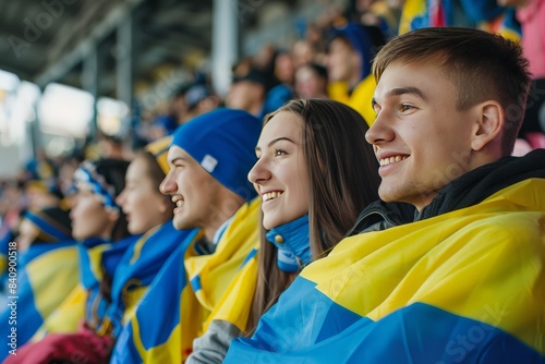 Brightly clad Ukrainian fans in blue and yellow, smiling and enjoying a sporting event, evoking a sense of national pride photo