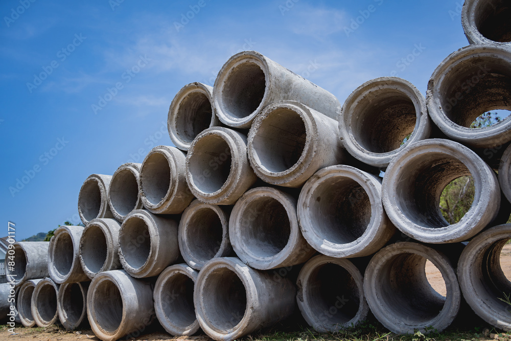 A stack of concrete ring pipes piled and creating a symmetrical arrangement A stack of concrete ring pipes piled and creating a symmetrical arrangement