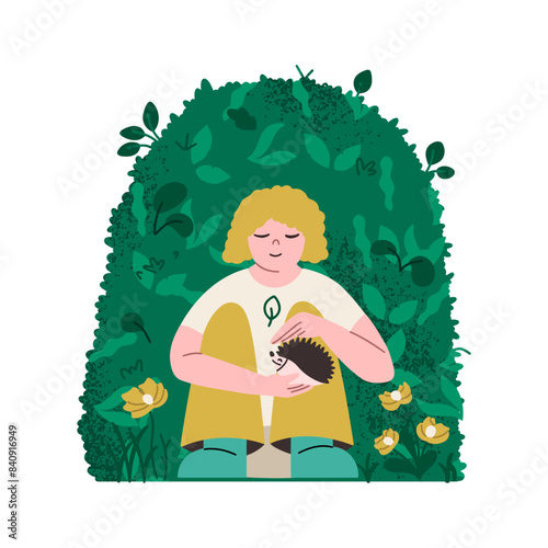The concept of the beneficial effects of the environment on the mental health of the child. A girl in nature holds a hedgehog in her hands. The concept of caring for the environment, animals.