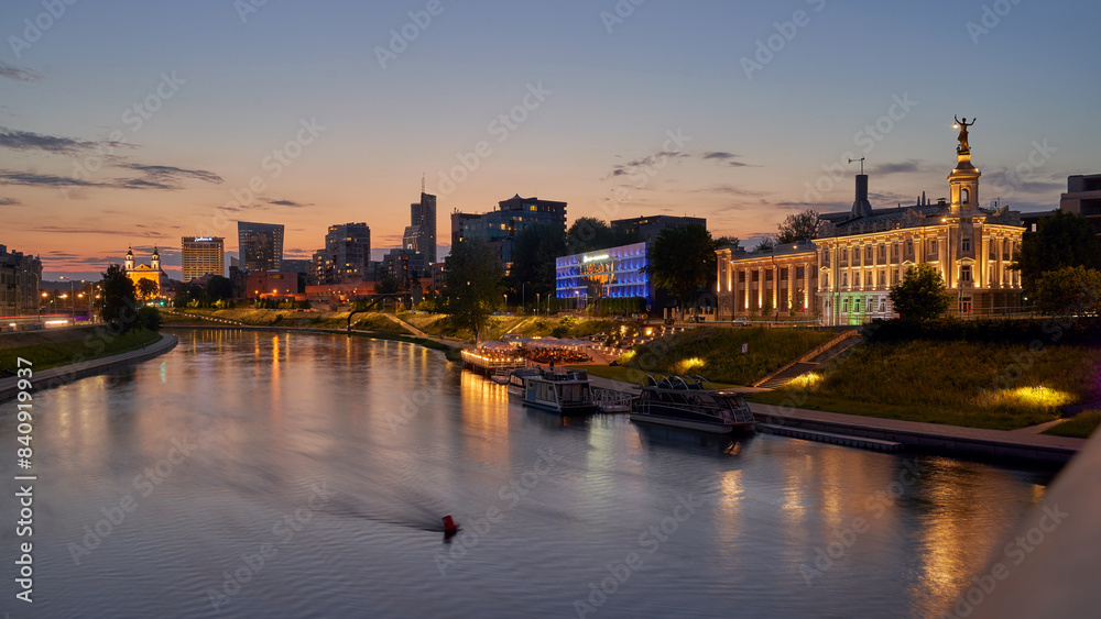 Vilnius night sunset panoramic cityscape with Neris river, church and skyscrapers of New Center. Lithuania, Baltic states.