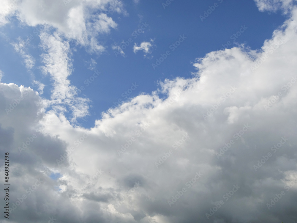 Expressive and moody blue cloudy sky. Nature background for design. Calm and surreal mood.