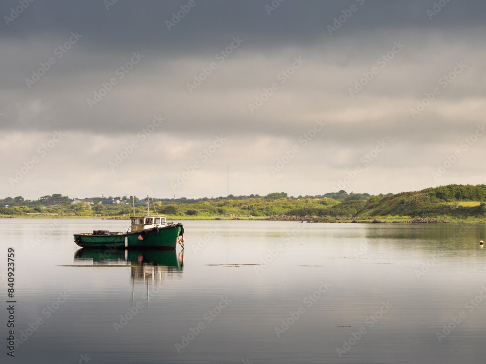 Small fishing boat in a calm ocean water. Travel and sport industry concept. Food supply chain. Small fishing boat in a calm ocean water. Travel and sport industry concept. Food supply chain.