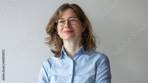 a woman in a blue shirt and glasses is smiling and looking out the window. she is wearing a tie and she is in a good mood isolated on white background, studio photography, png photo